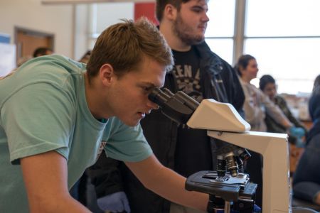 Student looking through a microscope