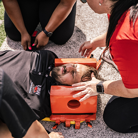 Students and Faculty helping an athlete during a simulation exercise