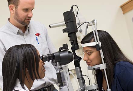 student looking through microscope