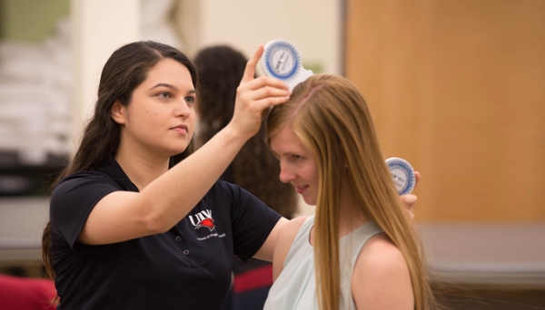 Physical Therapy student examining a patient
