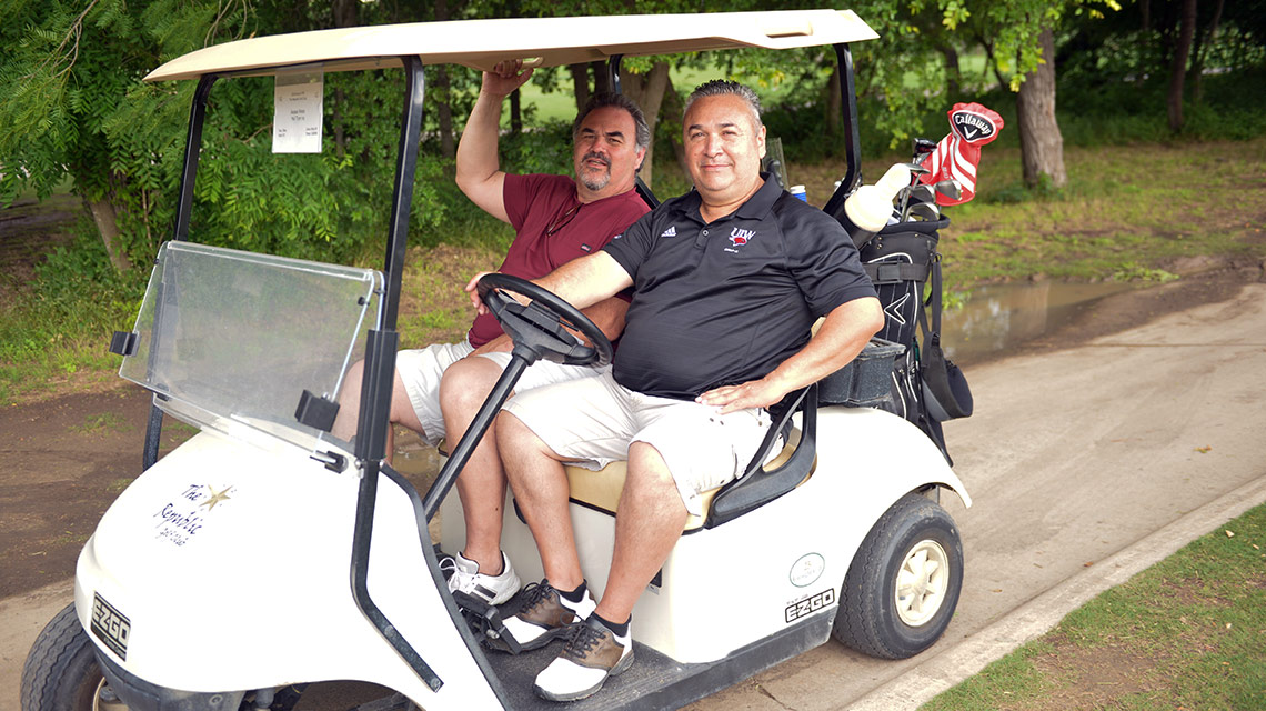 golfers in golf cart