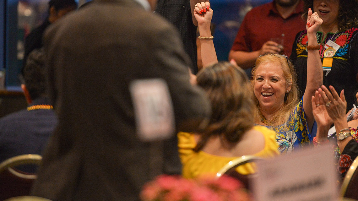 woman excited smiling with hands up