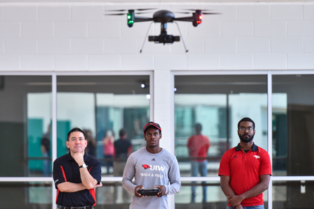 professor and students working with drones