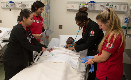 Four nursing students doing an exam