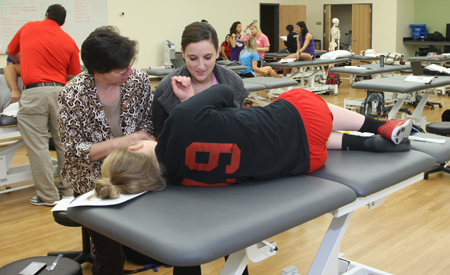 Instructor with a student giving an exam