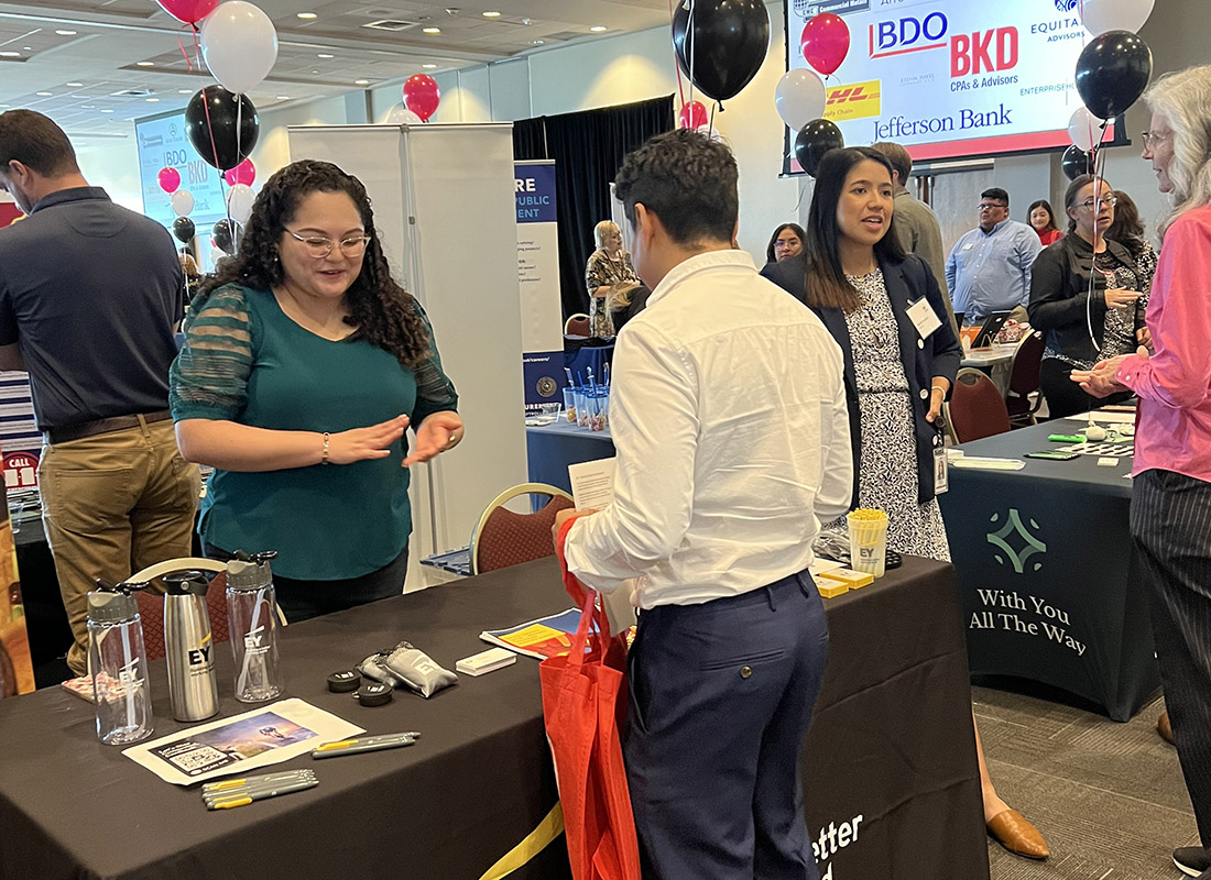 student talking to an employer at the career fair