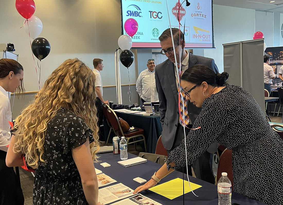 career fair attendees chatting at a table