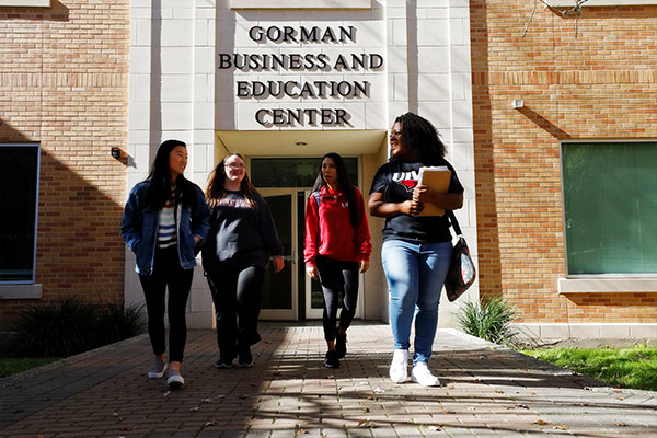 Students walking in front of business building