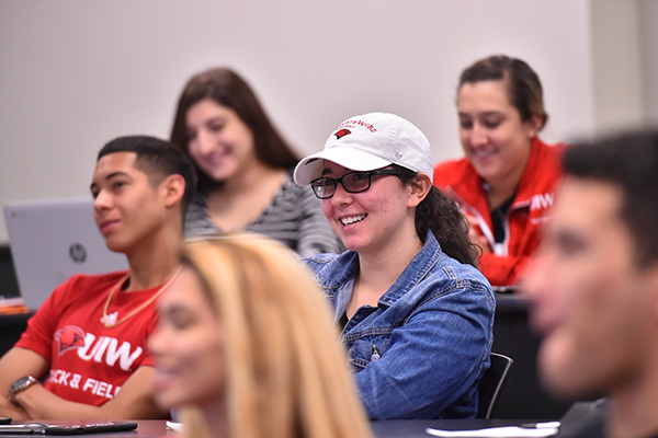 Student in classroom smiling