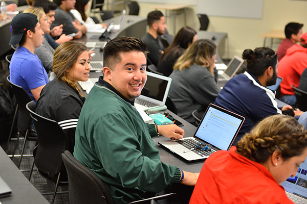 student smiles at camera during class