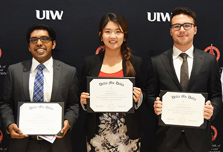 Students at Delta Mu Delta induction