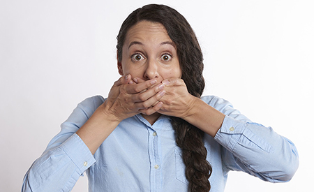 stock photo woman covers mouth