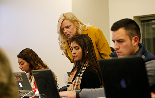 Instructor and student on a laptop