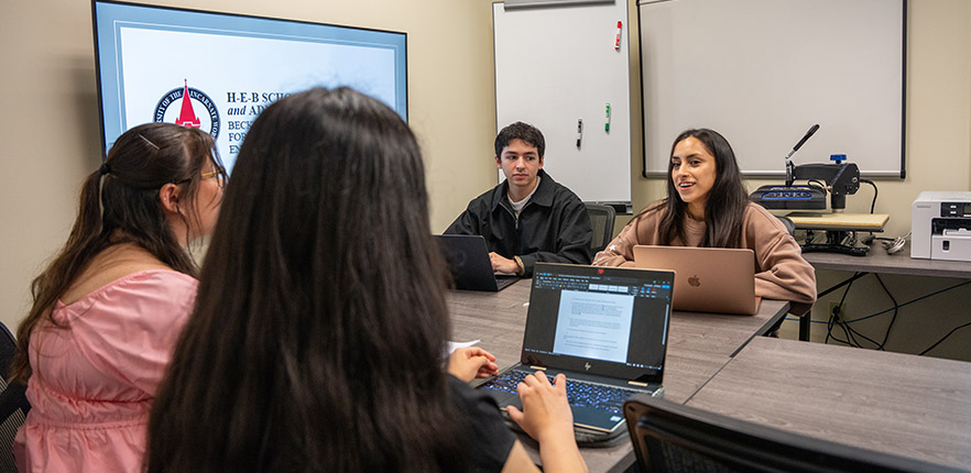 four students working around a table