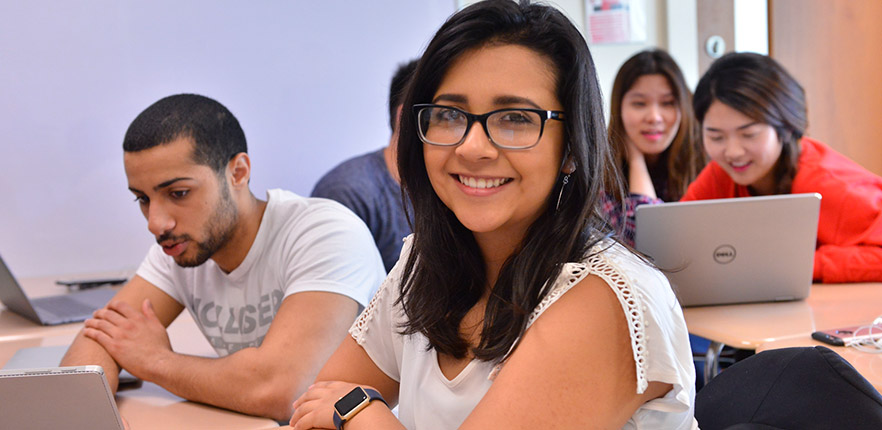 HEBSBA undergraduate student smiling in class