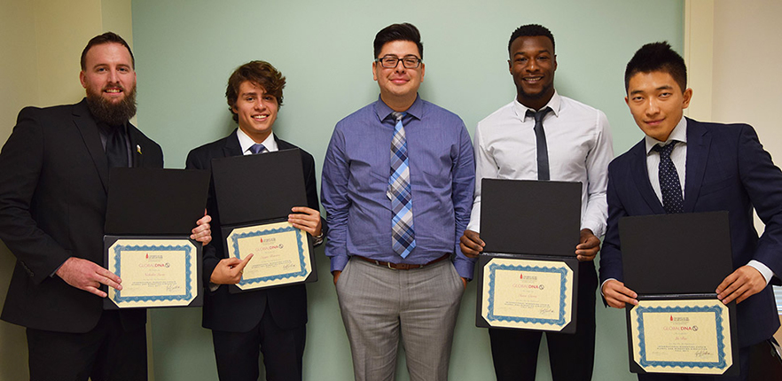 Dr. Saldivar presents certificates to students