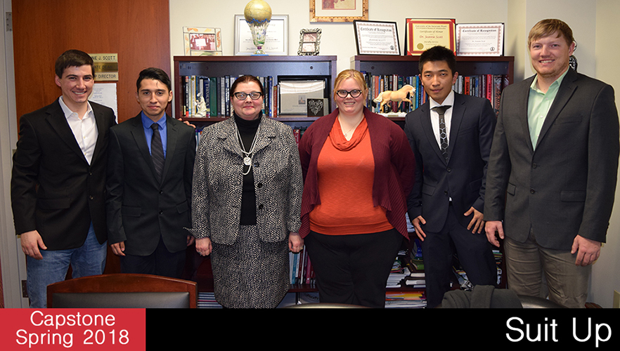 capstone students pose with suit up client