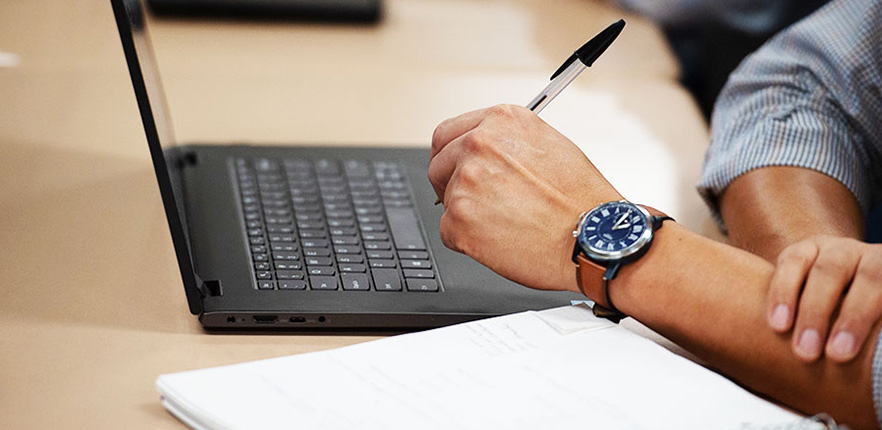 man writing on paper