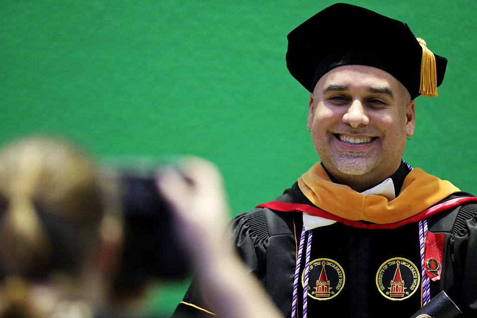 Graduate smiling at the camera