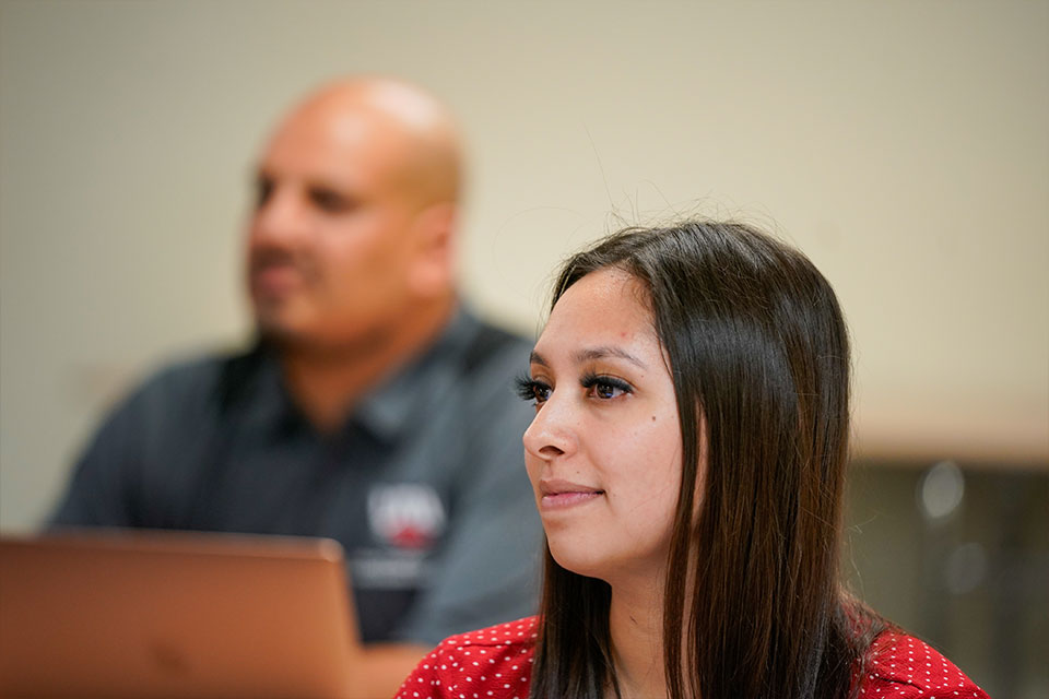 Woman's face looking forward with another student in background