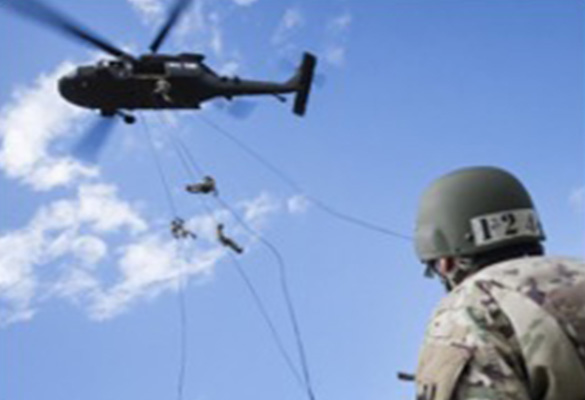 ROTC Student looking up at a helicopter during training