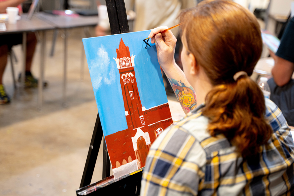Female student veteran painting a canvas