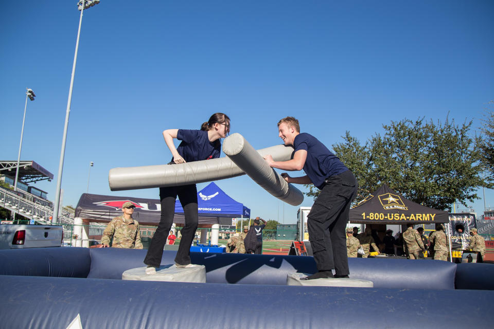 Two Marine poolees playing inflatable jousting