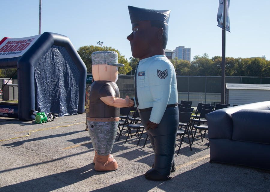 Army ROTC and Air Force mascots shake hands