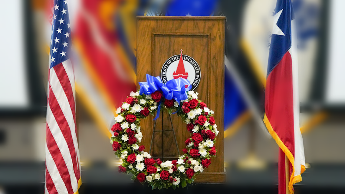 Patriotic-themed wreath placed in front of UIW podium 