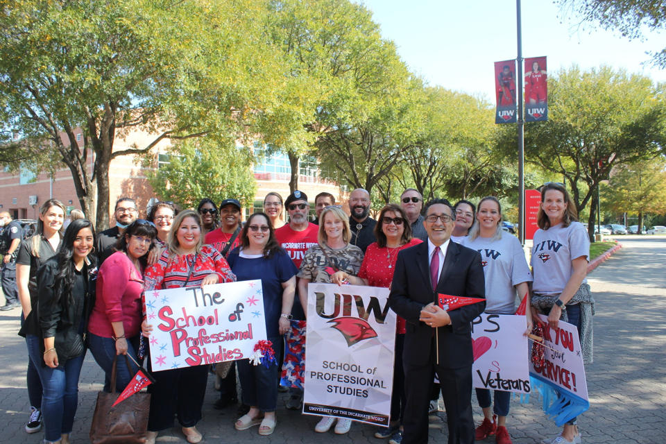 UIW School of Professional Studies holding Thank You signs
