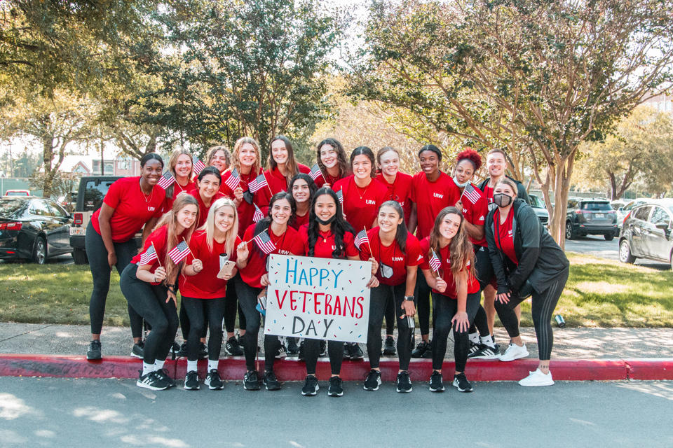 UIW student athletes holding Happy Veterans Day sign