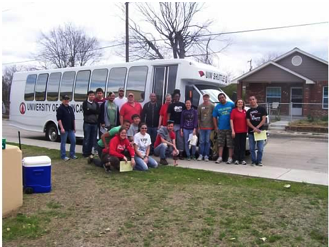 students in front of a bus