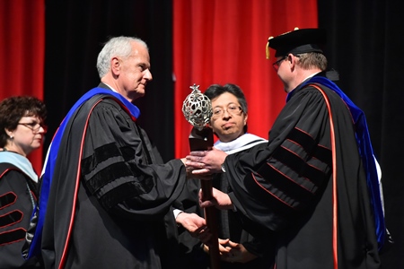 Dr. Evans accepts the Inaugural Symbols