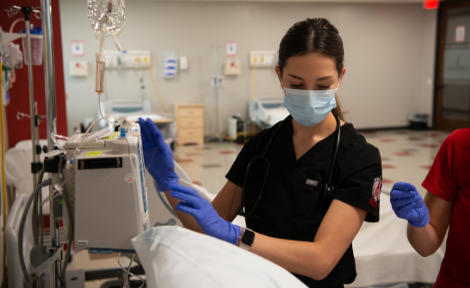 Nursing student checks patient