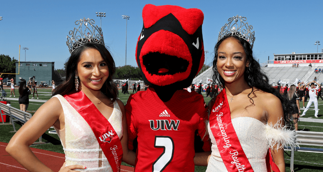 Homecoming royalty poses with Red the Cardinal