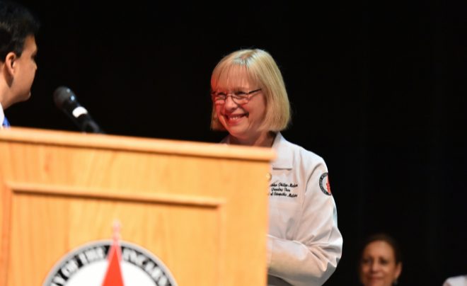 Woman in white coat smiling