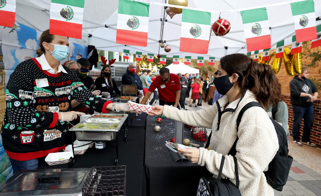 Student receiving food at the station celebrating Mexico