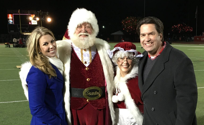 KSAT's Steve Spriester and Myra Arthur pose with Santa and Mrs. Clause after Light the Way at Benson Stadium