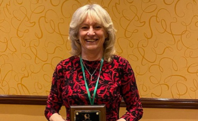 Woman smiling holding award