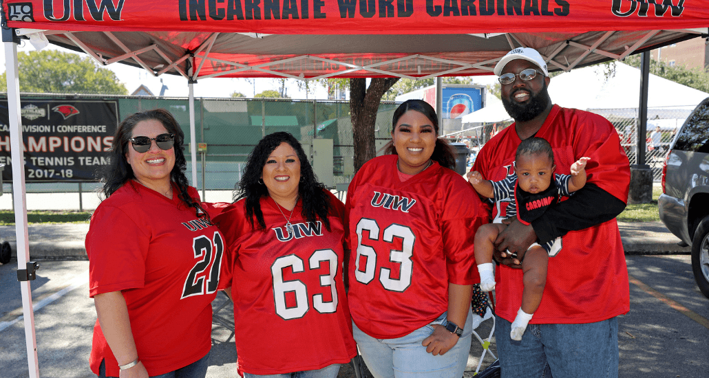 People in red posing under a red tent