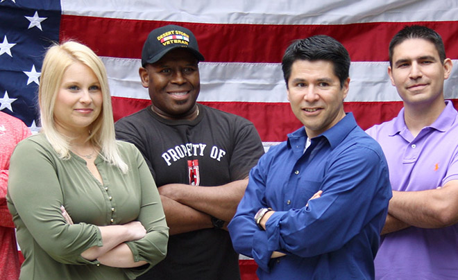 Military students posing before a flag