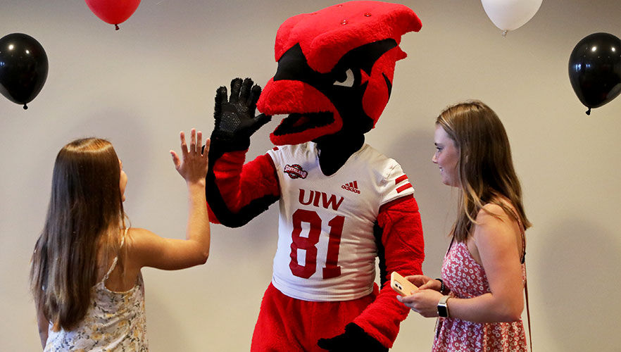 Red high-fiving student