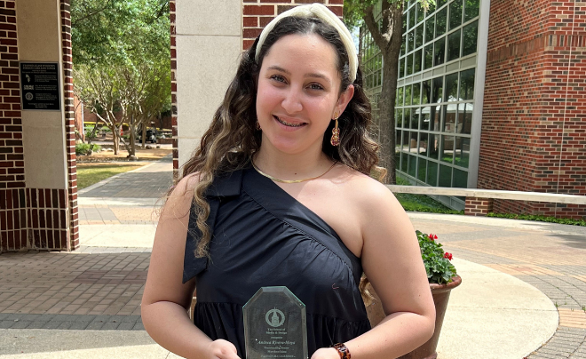 Andrea Rivera poses with her Outstanding Senior award