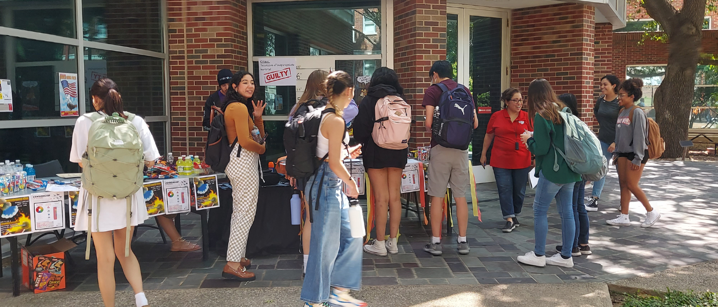 Students at a table discussing banned books