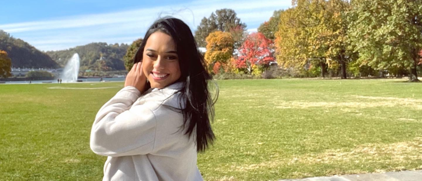 Brittnay Hernandez in front of a field