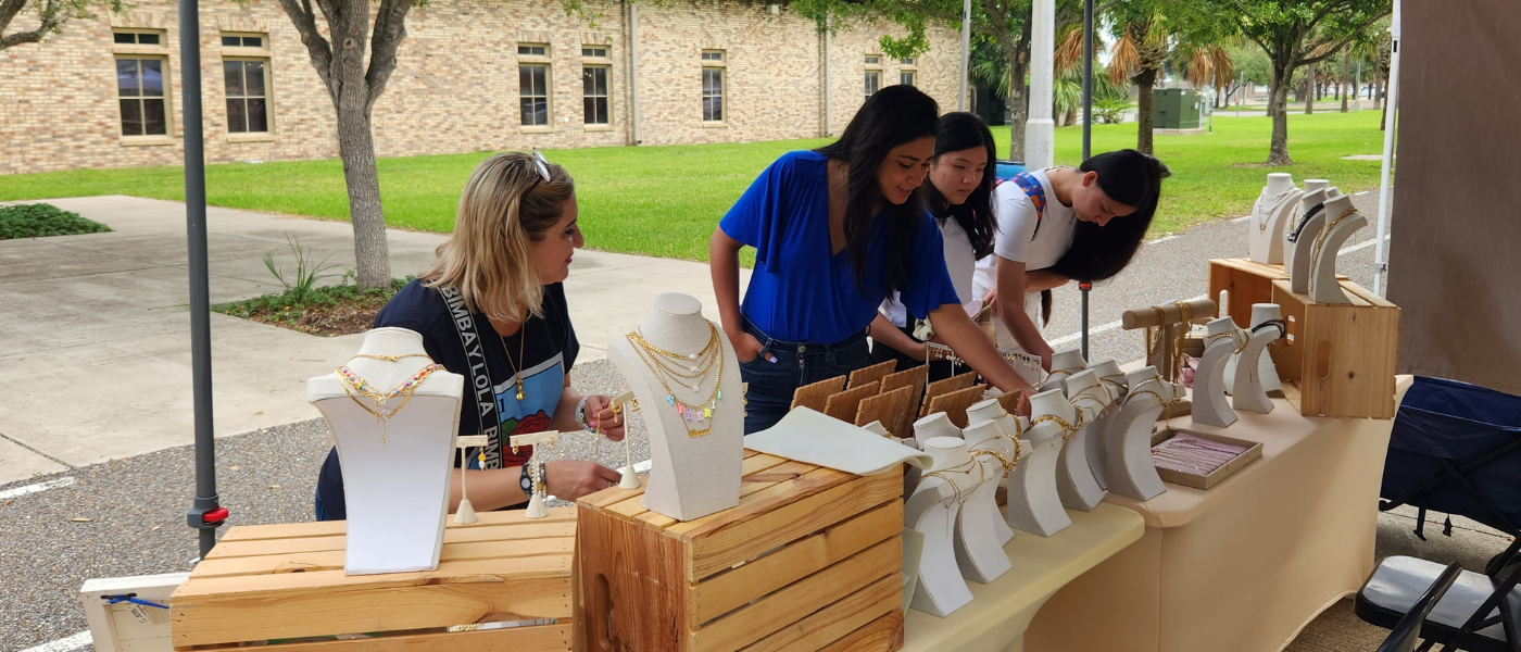 UIW students looking at jewlery at a market