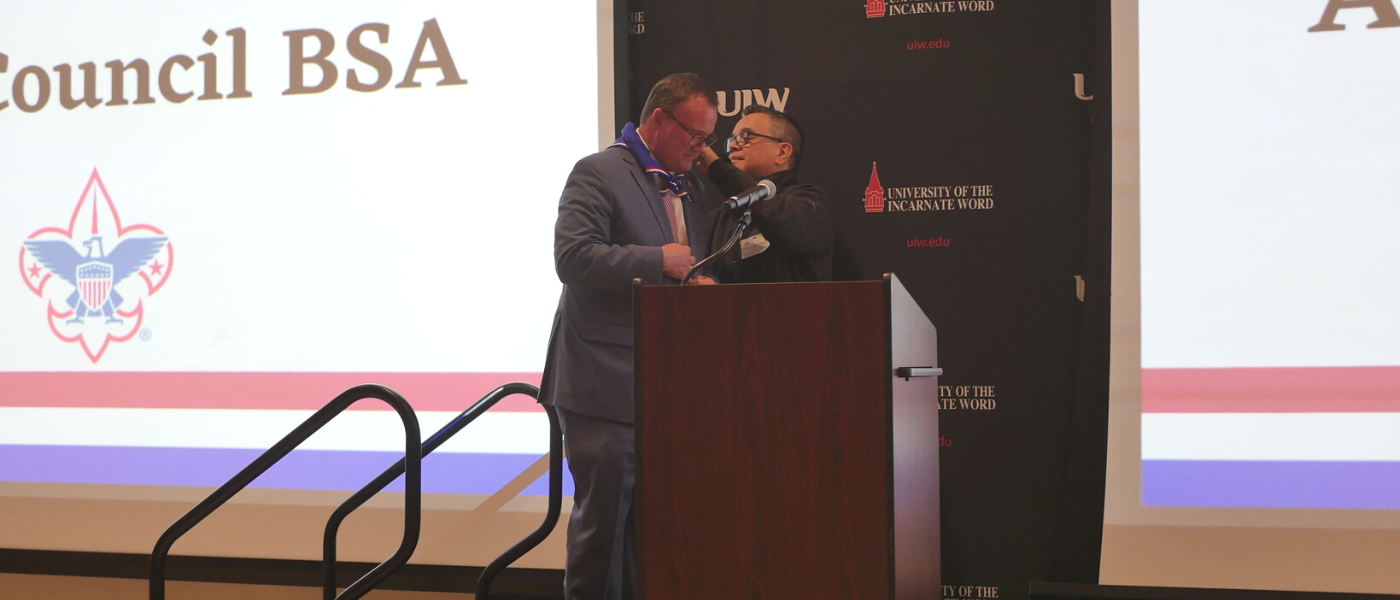 Thomas M. Evans, PhD, receives an Eagle Scout neckerchief by de los Santos