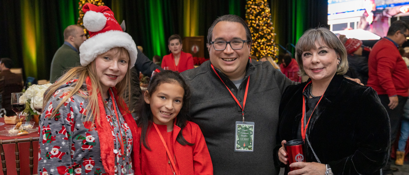 Two adults and two children smiling