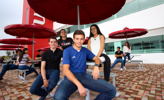 Four students smile for the camera