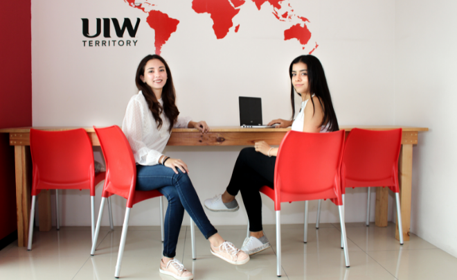 Two UIW students sitting at desk
